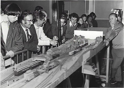 Visitors crowd around an early club layout at an exhibition