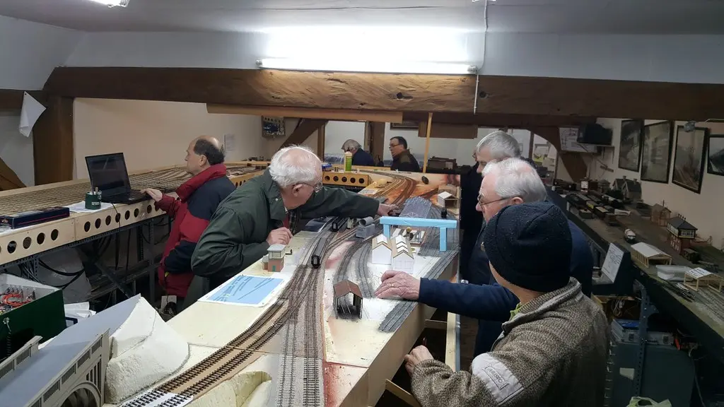 Members planning around laptops and drawings on a club night
