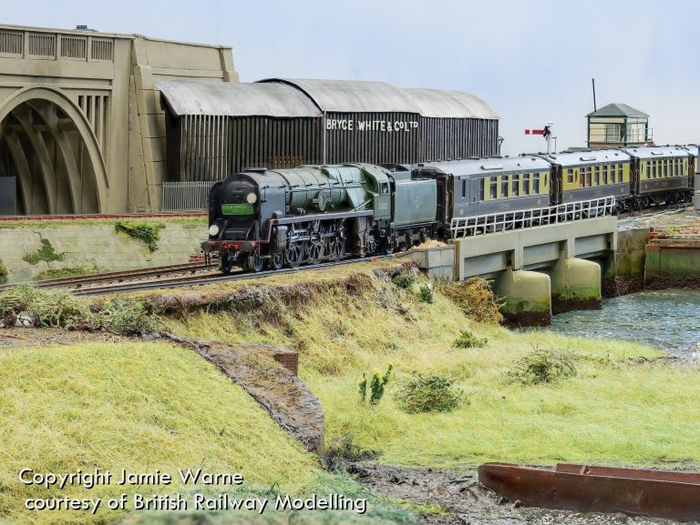 Rebuilt Bulleid Pacific in BR green leading green coaches across the causeway at Redbridge Wharf