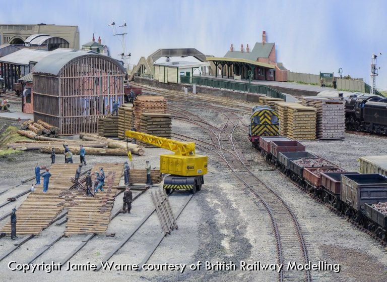 Gangers at work among timber stacks and a shunter in the Redbridge works yard