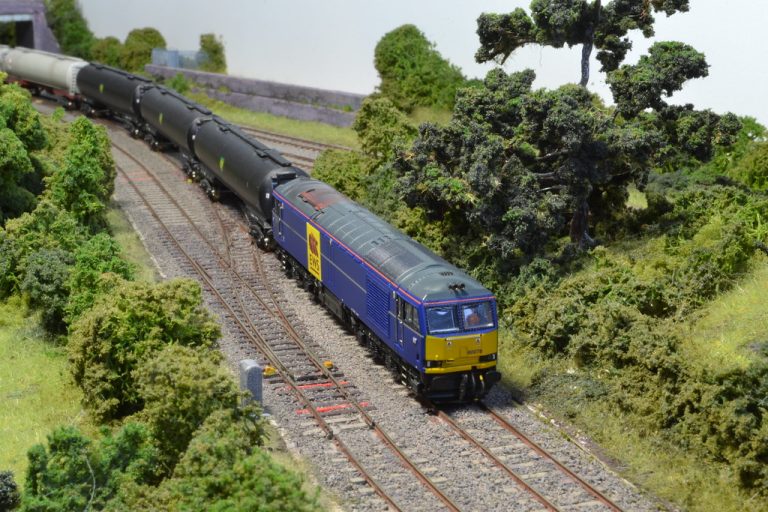 Blue Class 66 with a train of bogie hoppers at Waton